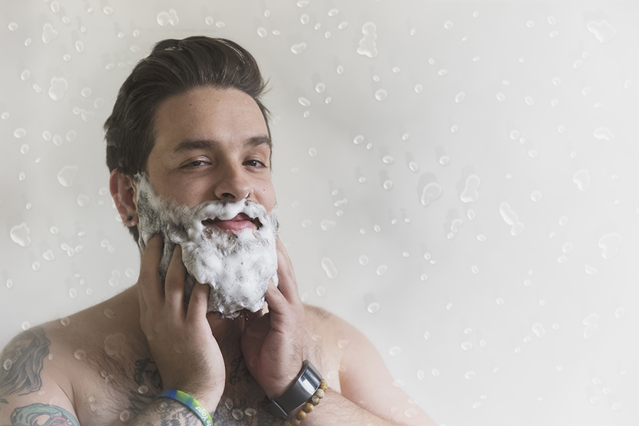 man washing his beard